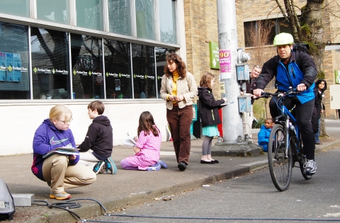Sixth-grade students from Rochester, N.Y., count bicyclists and pedestrians along Portland's Broadway cycle track with help from pneumatic-tube counters and infrared sensors. The students were visiting Portland to learn how to make Rochester more bike friendly.
