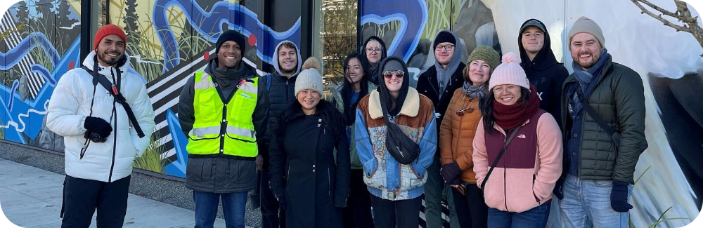 Member of the Community Transportation Academy pose for an outdoor photo in the wintertime