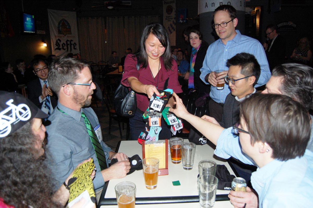 Hau hands out socks as a trivia prize at the 2016 TRB Reception