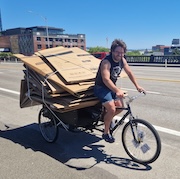 Ryan Hashagen on a bike loaded up with cargo