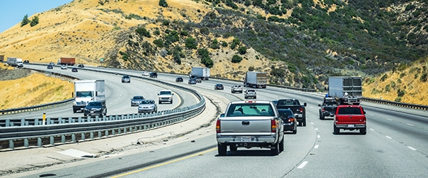 Cars on the freeway in a desert setting