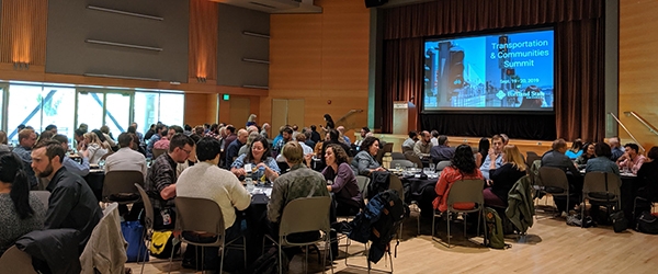 A view of the ballroom with attendees eating lunch during the Summit keynote