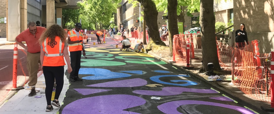 A student-designed street painting honoring Pride was painted by volunteers during the Montgomery Pop-Up Plaza.jpg