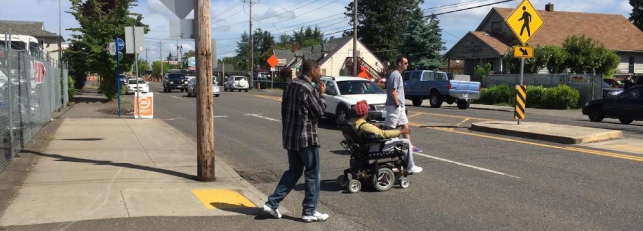 pedestrians cross the street