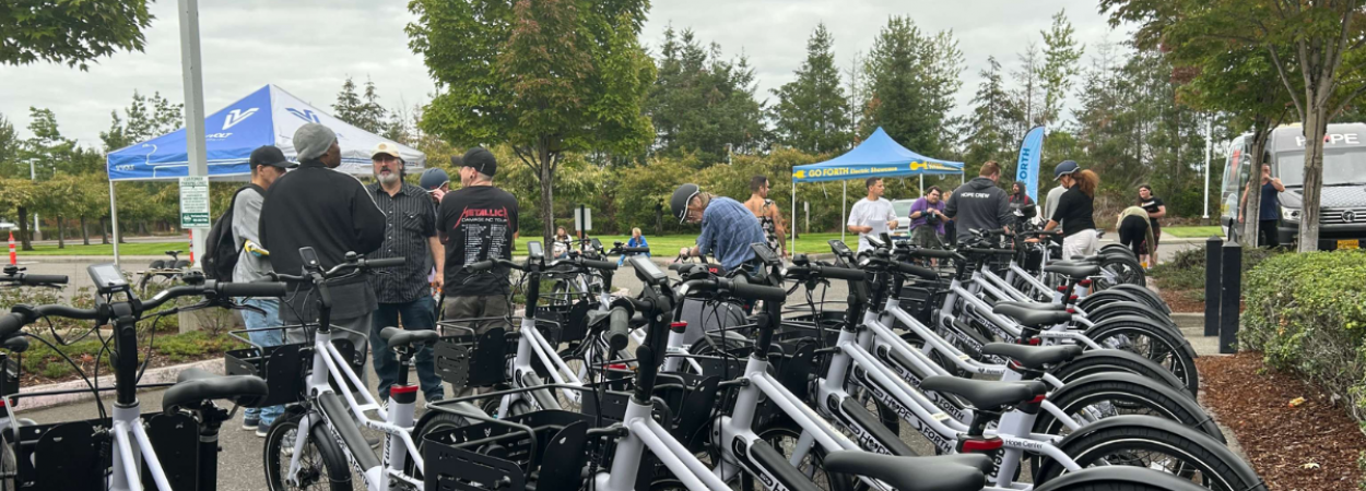E-bikes and people under tents during an outdoor e-bike event
