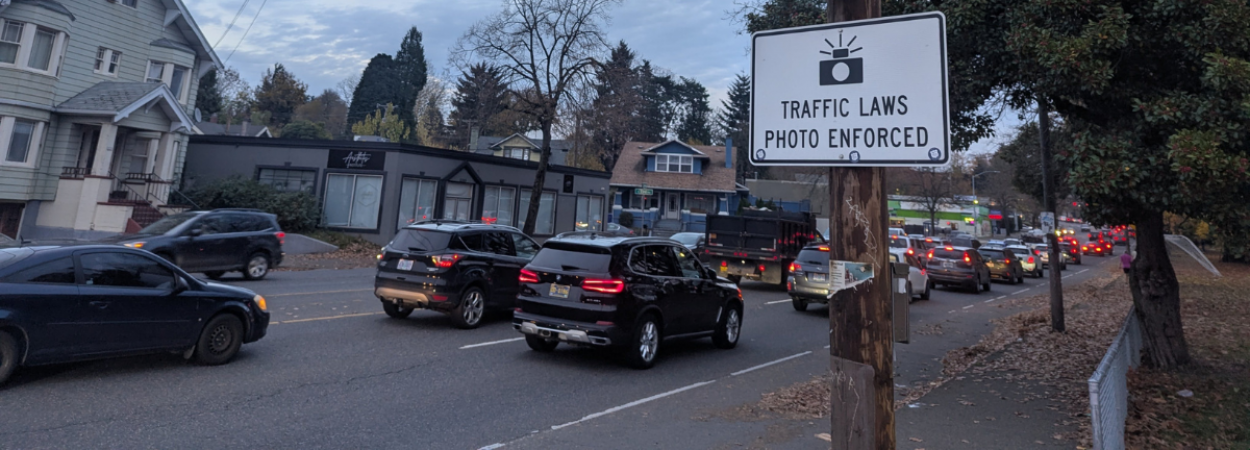 Sign on Portland's Powell Boulevard saying 'Traffic Laws Photo Enforced'