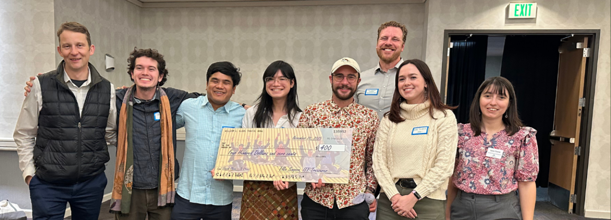 Members of the 2025 PSU ITE Traffic Bowl team pose with an oversized cardboard check.