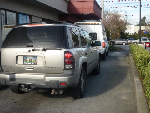 Cars idle in a drive-thru lane. Turning off engines while idling can reduce emissions and save fuel.