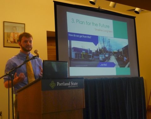 Jake Warr stands at the podium and presents Swift Planning Group's vision for a new Lombard street.