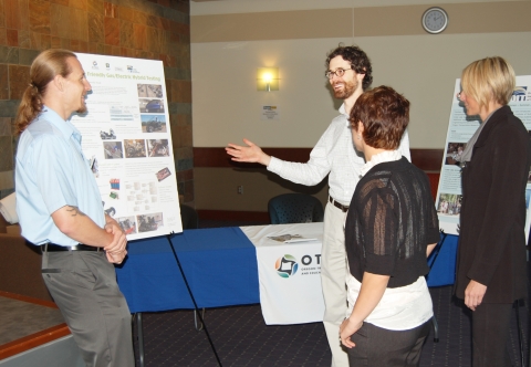 OTREC's Justin Carinci, center, explains an OTREC research project (http://otrec.us/project/497) being carried out at Oregon Tech during the opening of that university's Wilsonville campus Oct. 17.