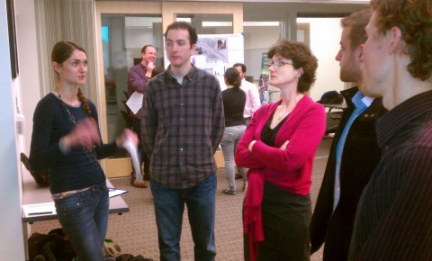 Students from OTREC researcher Christopher Monsere's transportation safety analysis course present safety recommendations for the Beaverton-Hillsdale Highway to Wendy Cawley, in red, city of Portland traffic safety engineer. The presentations were part of a March 19 open house for the course projects.
