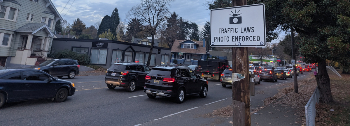 Sign on Portland's Powell Boulevard saying 'Traffic Laws Photo Enforced'